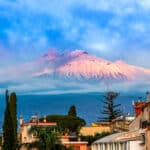 Taormina, Sicily, Italy: Panoramic view of the Etna seen over the city, in the sunrise lights